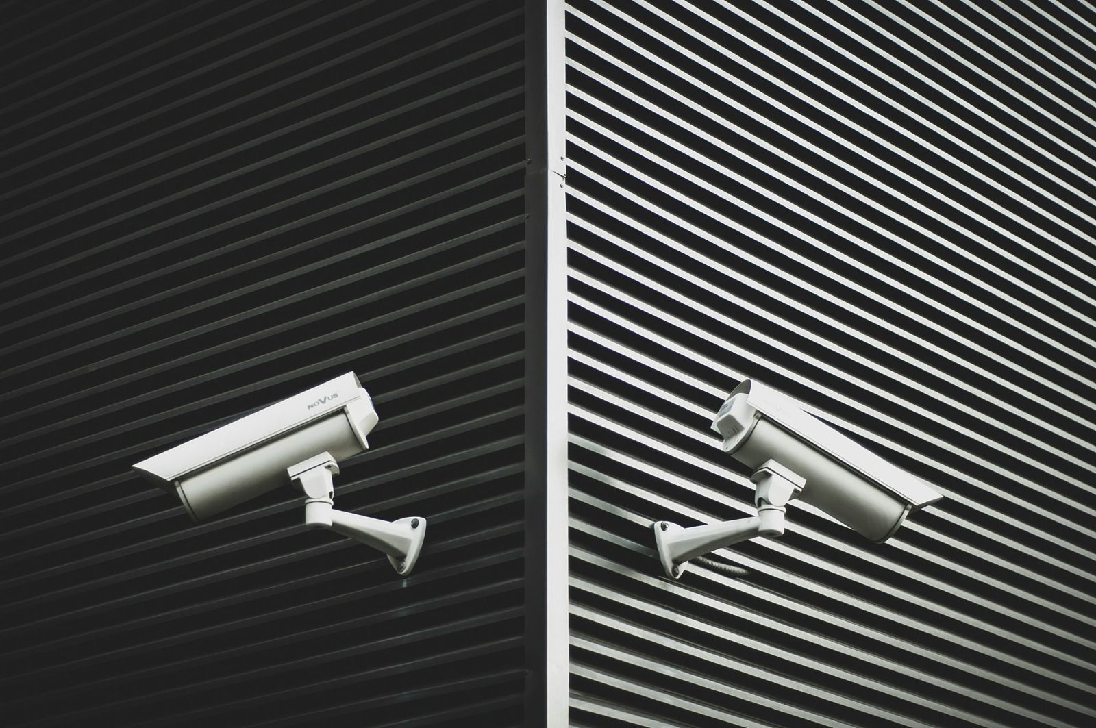 Two security cameras mounted on a building corner